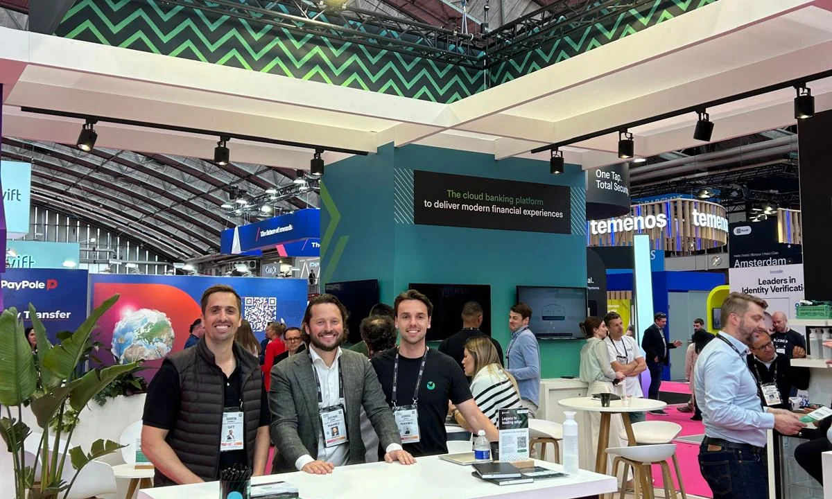 GFT and Mambu representatives standing together at the Mambu booth during the Money20/20 event, showcasing cloud banking technology under the slogan “Powering the future of banking.”