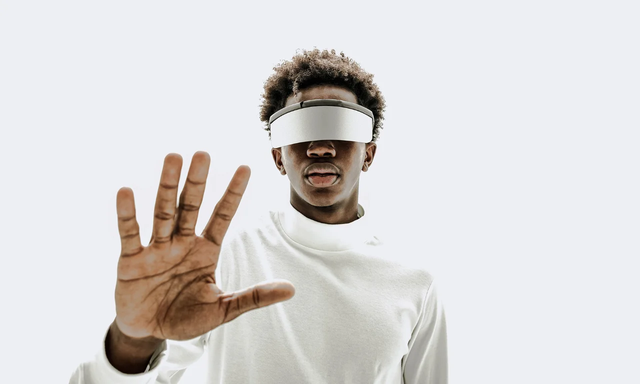 Individual wearing a virtual reality headset interacting with digital space, representing innovation and immersive technology.