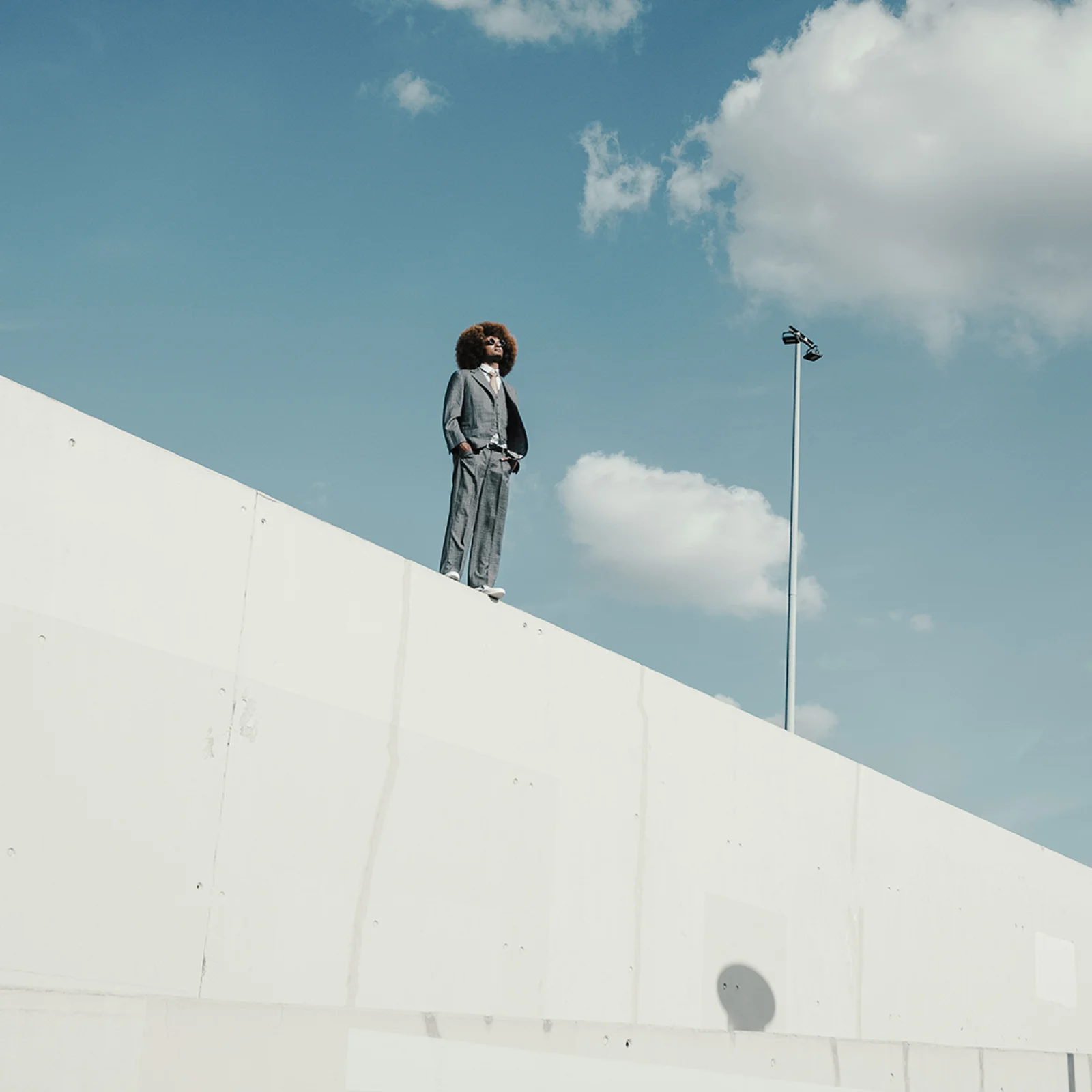 Visionary Leadership and Innovation at GFT Professional standing confidently on a modern rooftop against blue sky, symbolizing vision, leadership, and forward-thinking innovation.