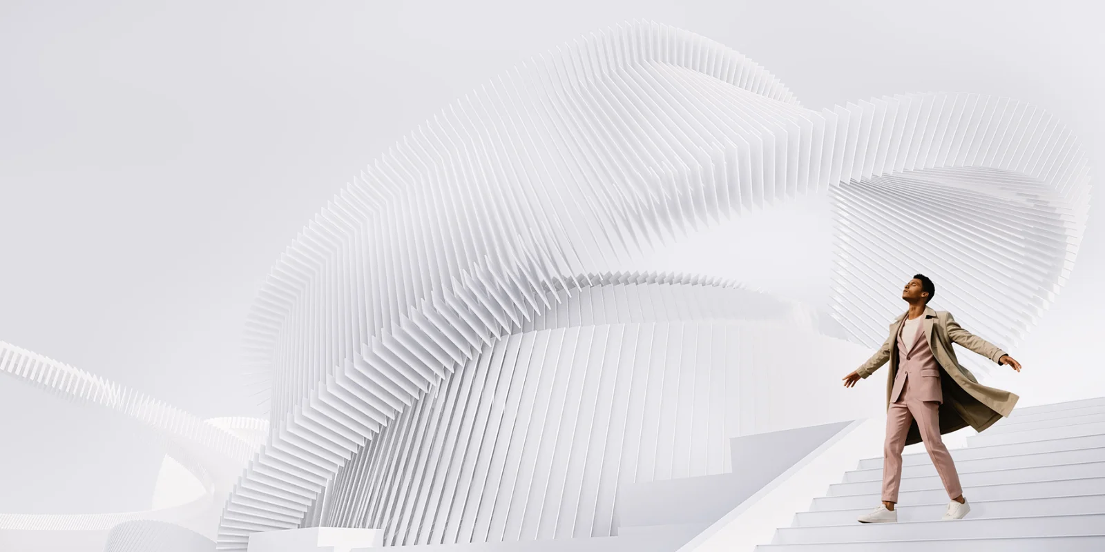 Professional walking confidently up white architectural steps with dynamic curved structures in the background, symbolizing progress and forward-thinking leadership.