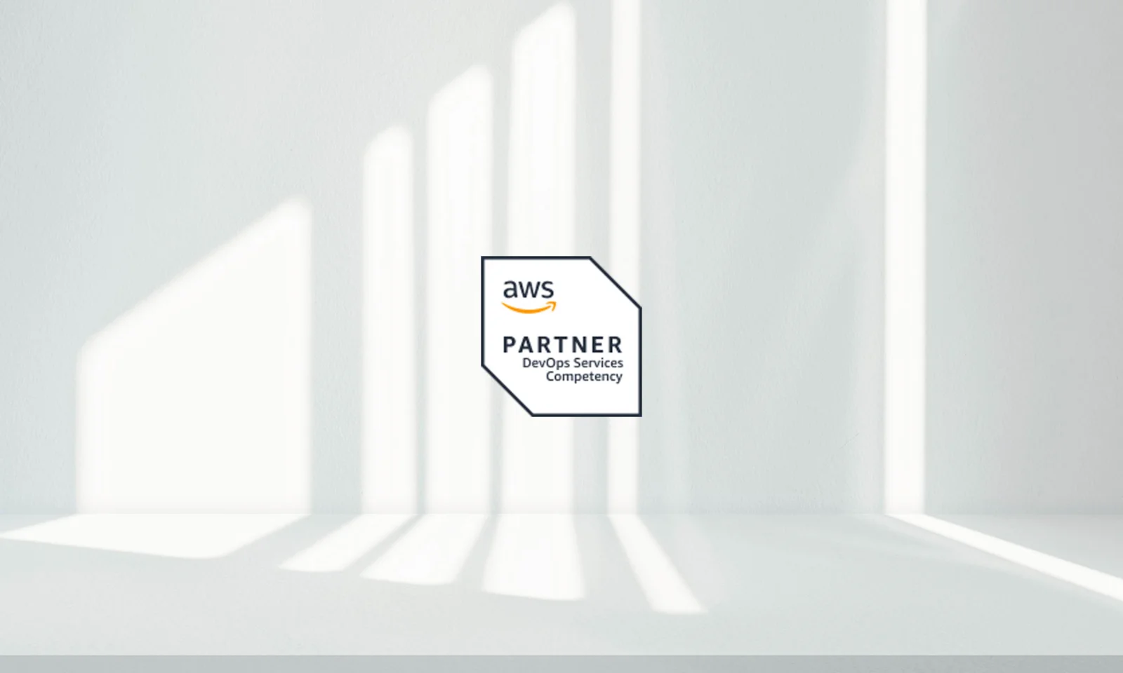 GFT AWS Partner DevOps Services Competency AWS Partner DevOps Services Competency badge displayed on a minimalist white background with natural light and shadows.
