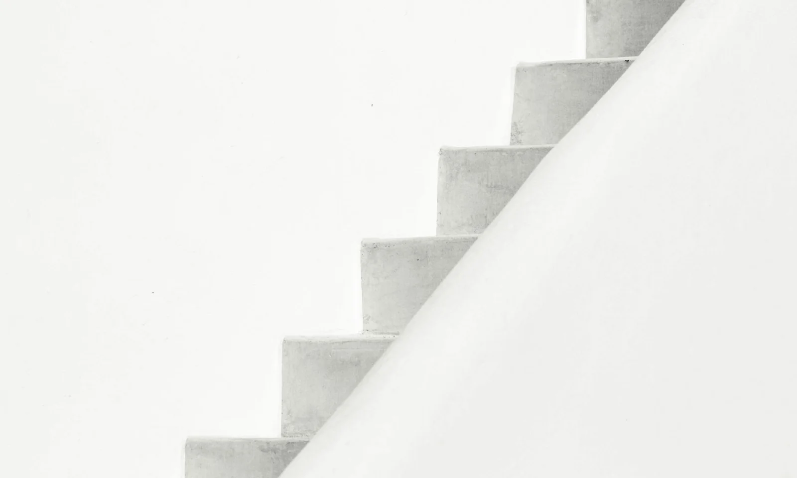 Abstract image of a white staircase with gentle shadows, creating a clean and modern geometric composition