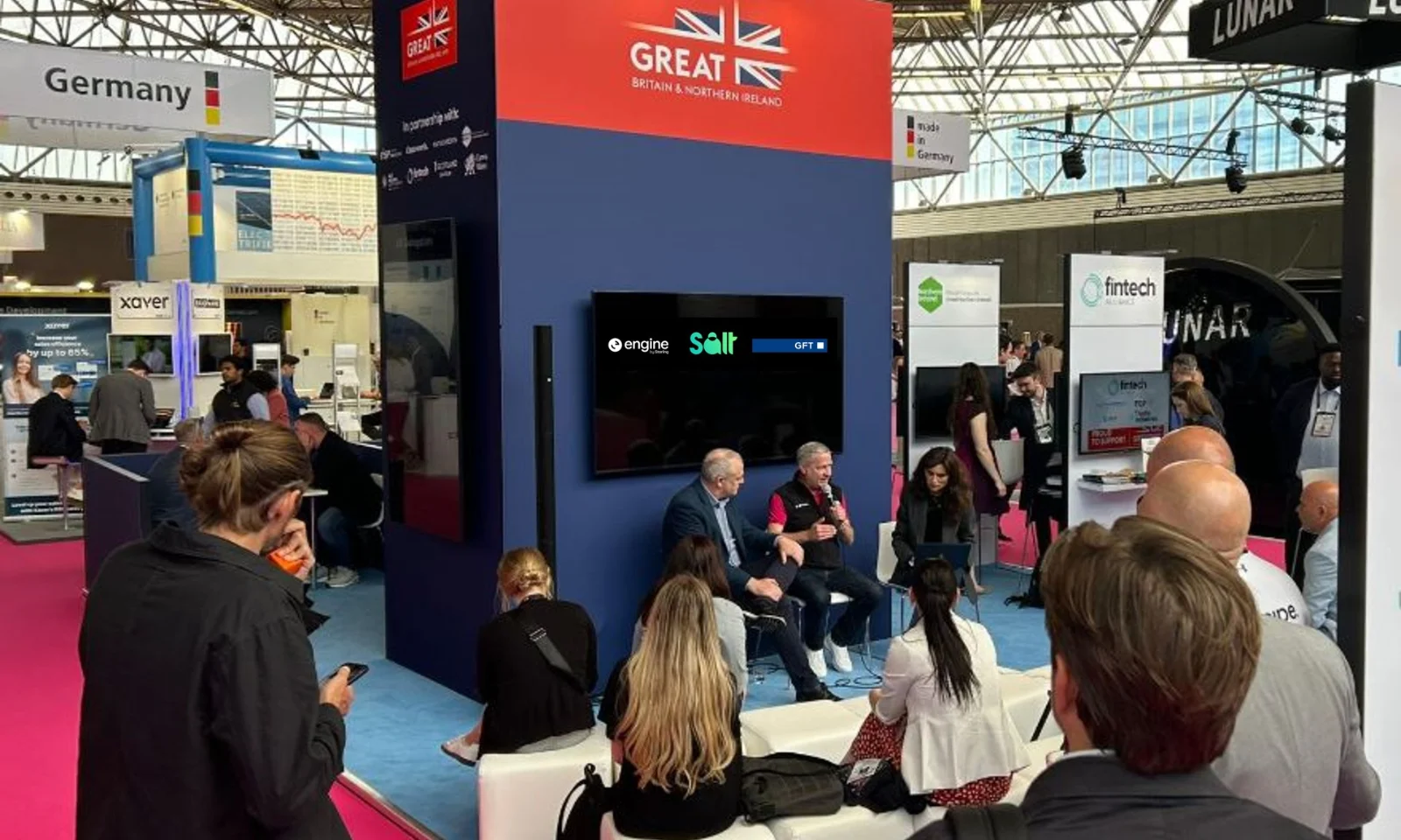 Audience gathered at the GREAT Britain &amp; Northern Ireland pavilion during Money20/20, where GFT, Engine, and Salt are featured as partners presenting fintech innovations.
