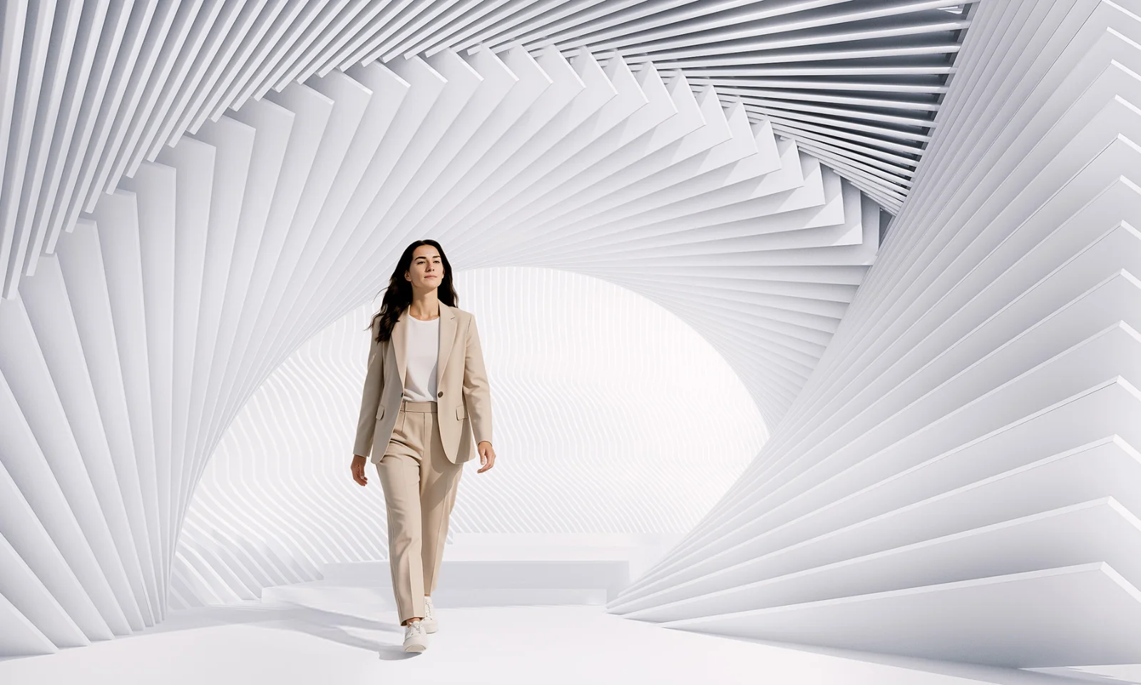 Business professional in digital innovation environment by GFT Confident business professional walking through futuristic white architectural space symbolizing innovation