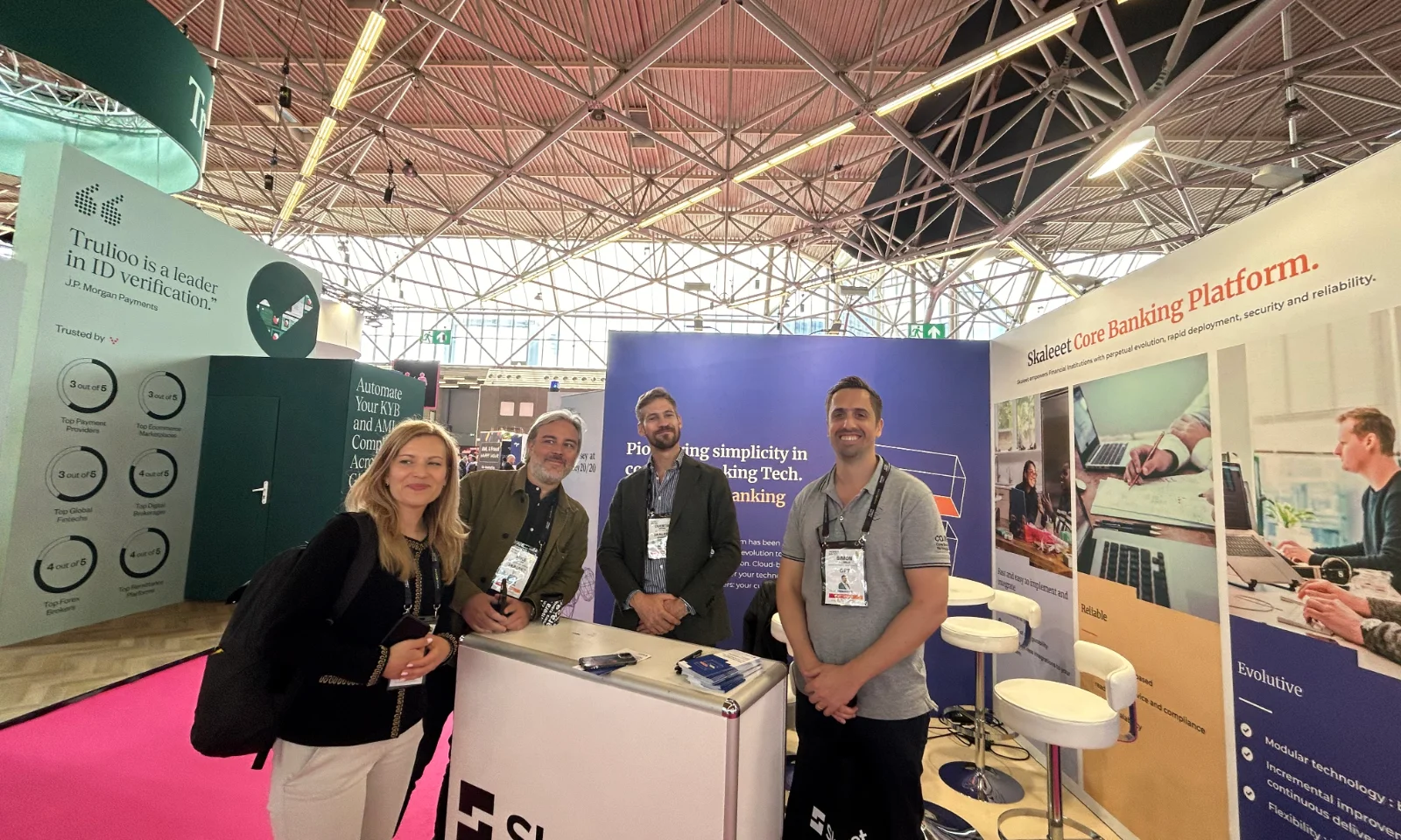 Group of professionals from GFT and Skaleet standing at the Skaleet booth during the Money20/20 event, showcasing the Skaleet Core Banking Platform.