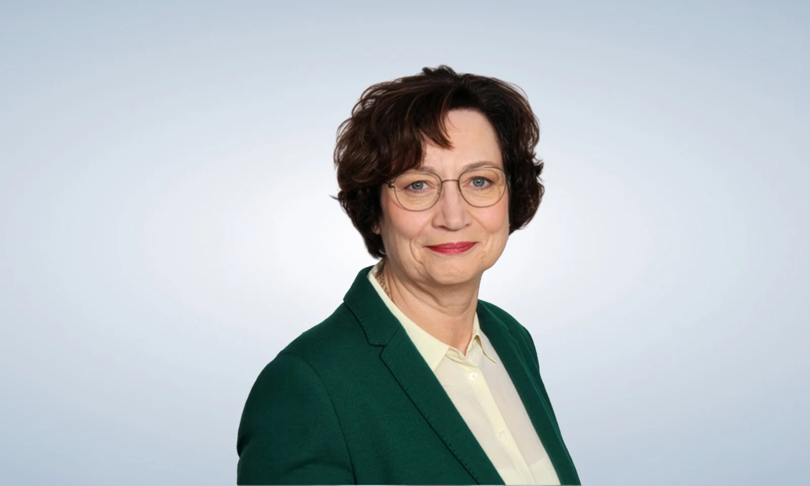 Professional portrait of a senior business leader in formal attire Smiling businesswoman wearing glasses, a black striped blouse, and a pearl necklace, posing against a light gradient background