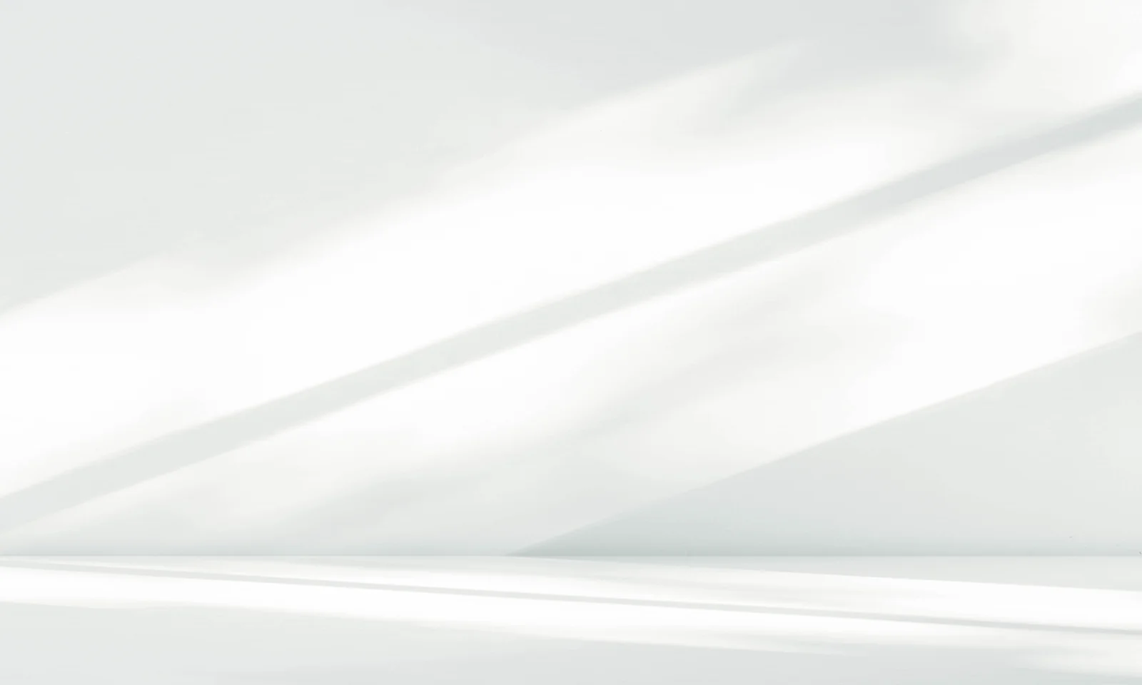 Minimalist White Background with Soft Light and Shadows Abstract white minimalist background with soft natural light and diagonal shadows creating a calm, modern atmosphere.