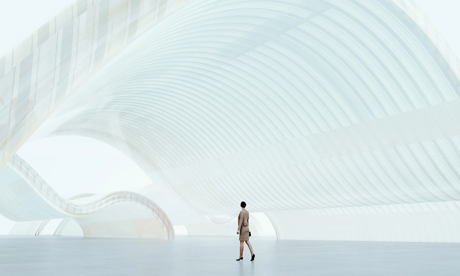 GFT Blog - Protegendo o amanha como fortalecer a ti na linha de frente da ciberseguranca Person walking through a futuristic, light-filled architectural space, symbolizing innovation, vision, and digital progress.