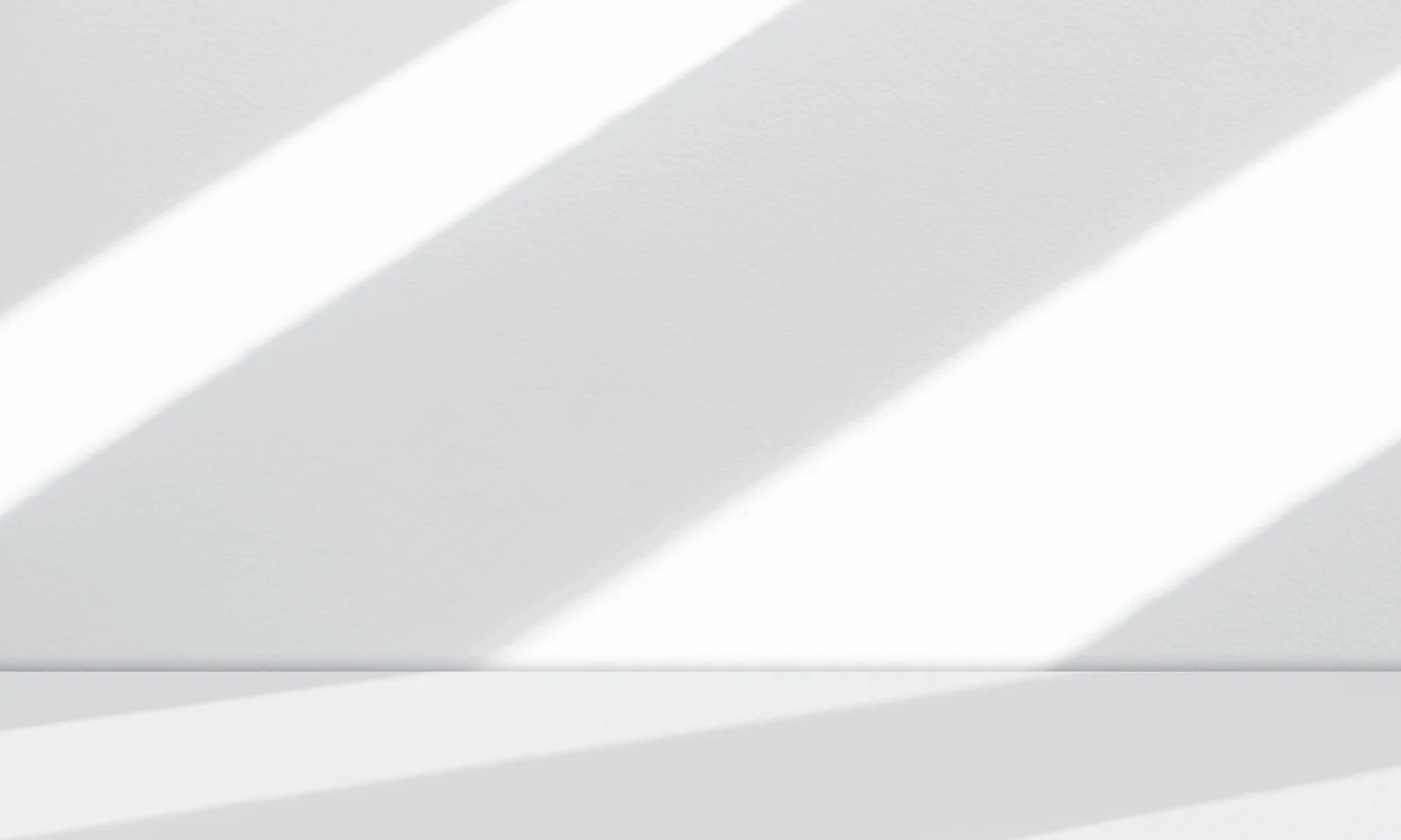 White textured wall and smooth surface featuring bold diagonal light beams and soft shadows in a minimalist setting.