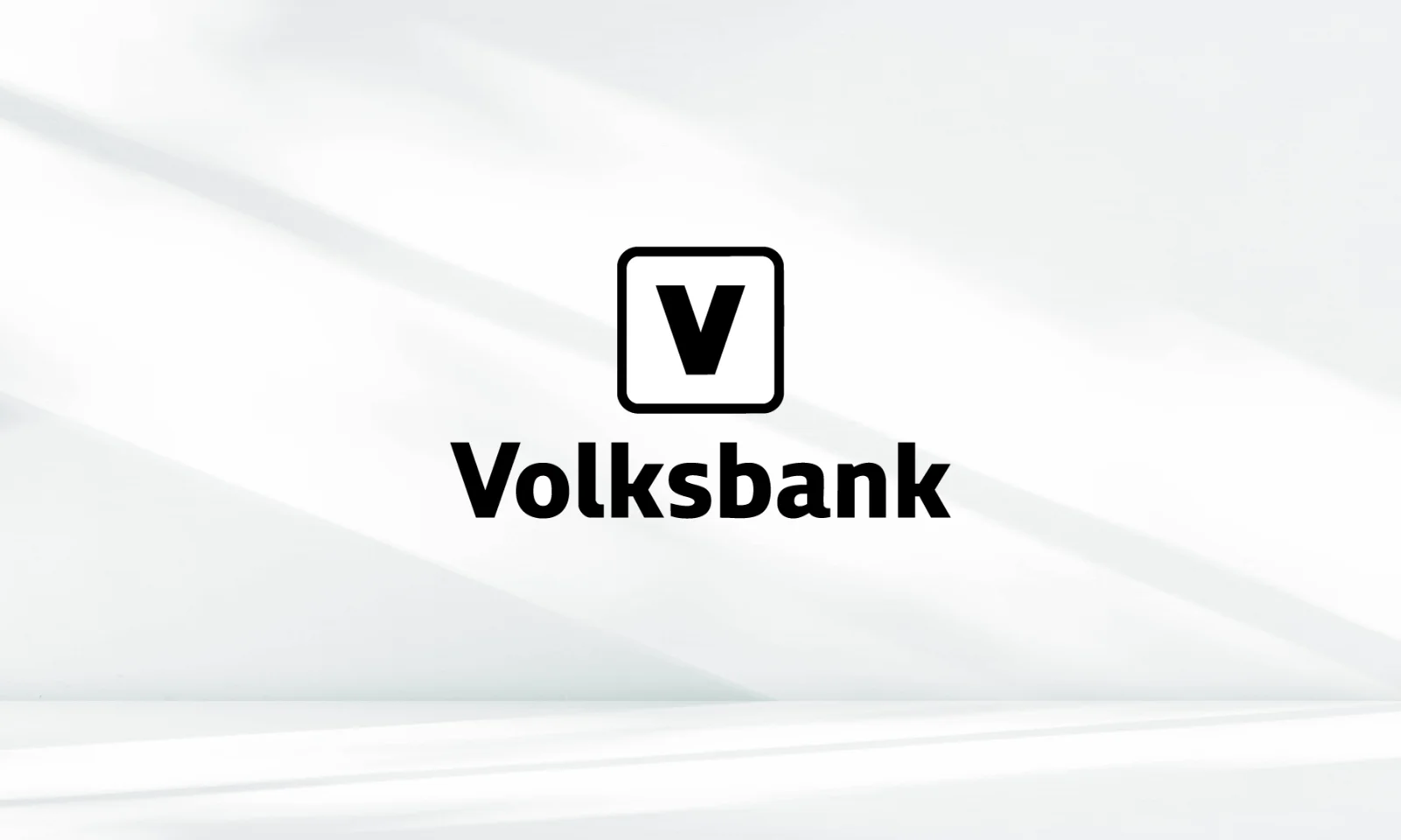 Volksbank Logo on White Background Black Volksbank logo with a bold “V” inside a rounded square above the word “Volksbank” on a minimalist white background with soft light shadows.