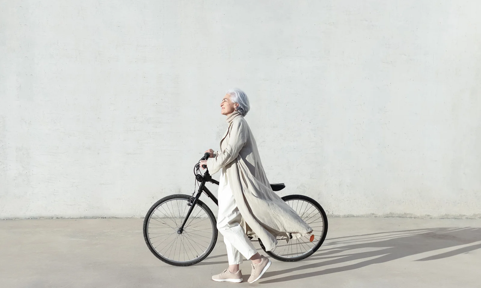 GFT Blog: Banking on Stablecoins Financial Institutions Lead the Wave of Digital Money Person walking beside a bicycle in bright sunlight, symbolizing progress, balance, and sustainable living.