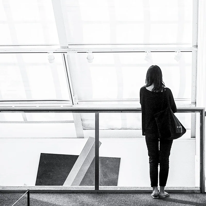 GFT - Agile and Devops Solutions Professional woman observing modern architecture in a bright workspace