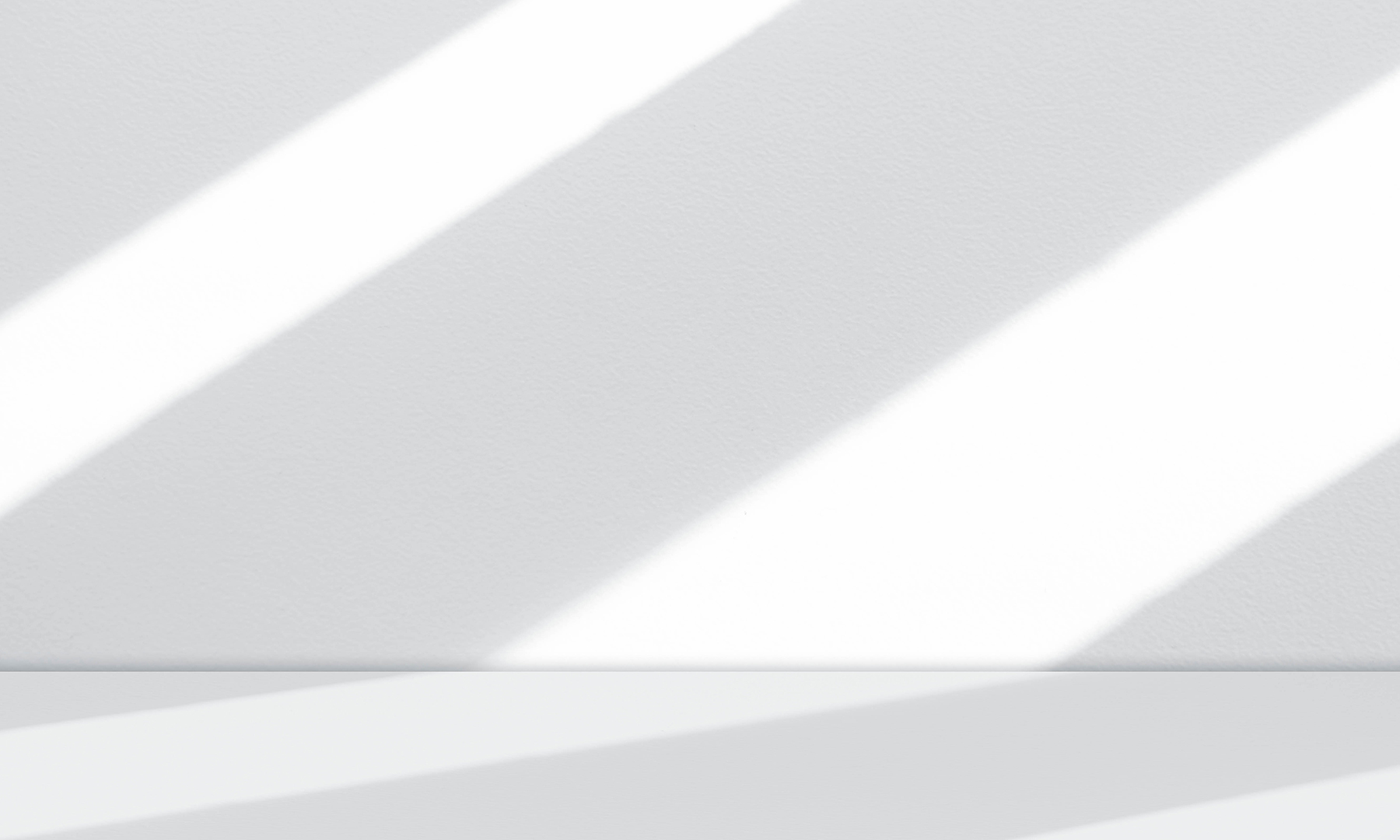 GFT Image - Shadow - 10 Strong diagonal beams of light casting sharp shadows across a smooth white textured wall and ledge in a minimalist setting
