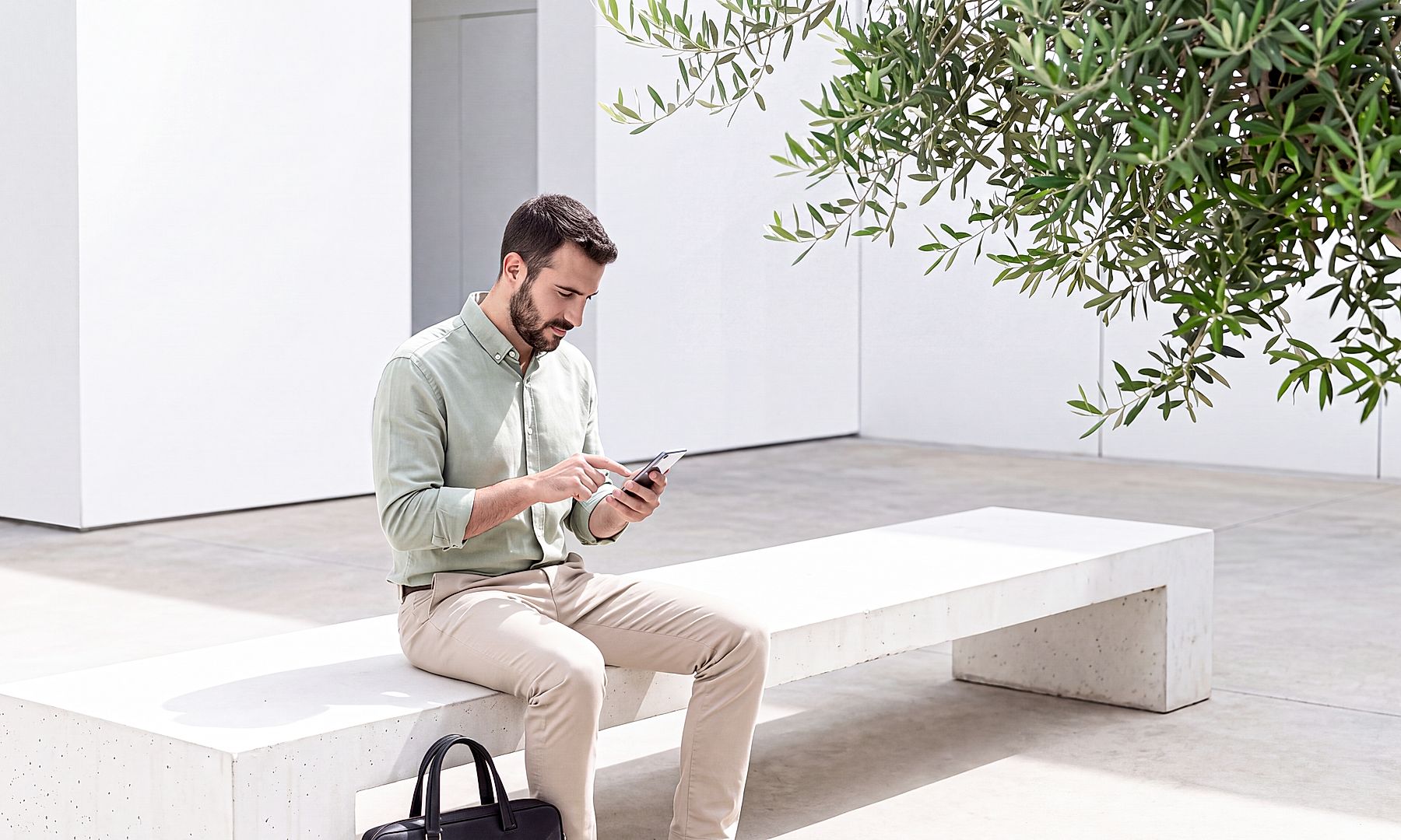 Young men having a break on a modern outdoor office environment This image highlights mobile-first business solutions, connected digital workflows, and seamless user experiences that enable organizations to improve productivity, collaboration, and digital transformation.