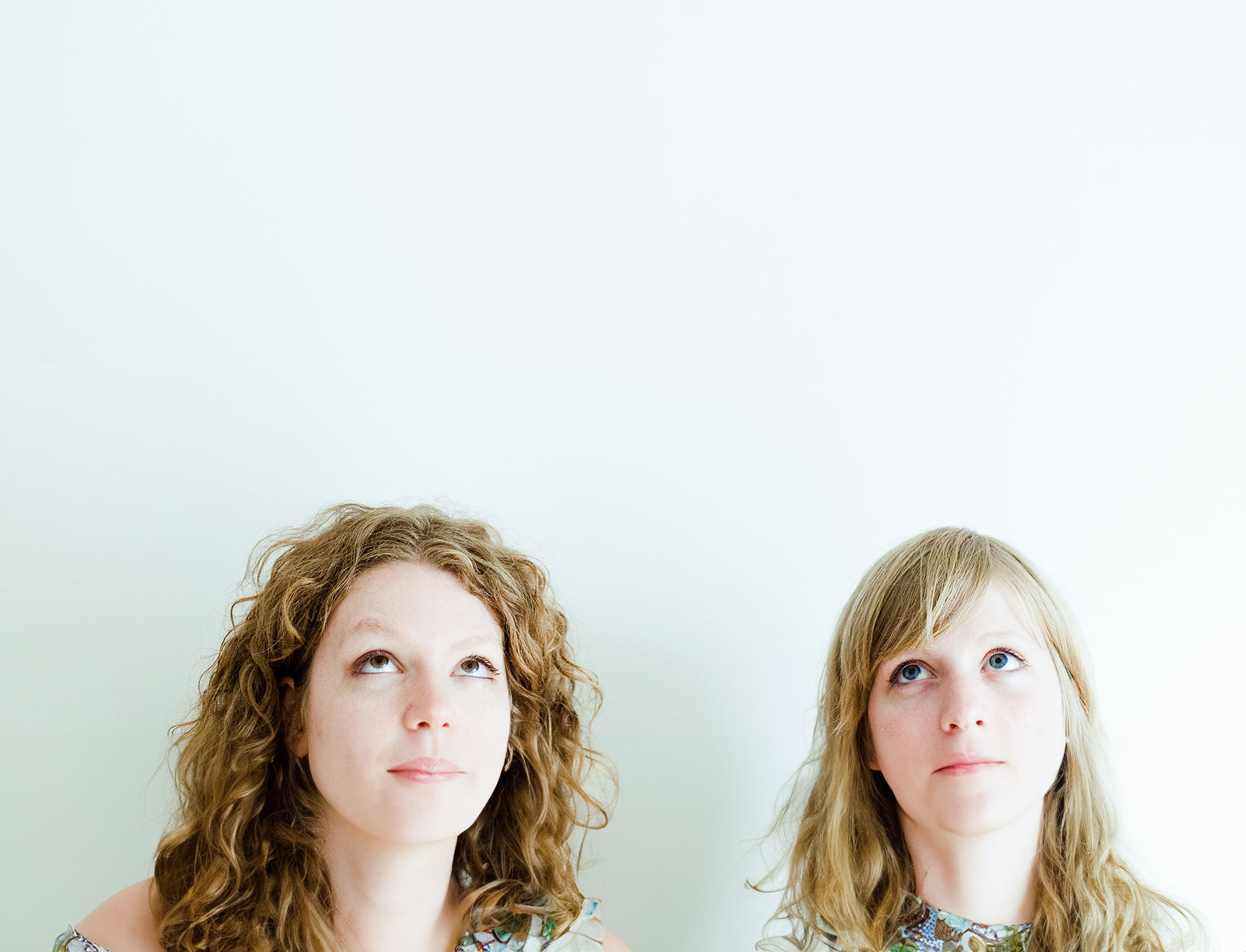 GFT Success Story: Db4Kids Two people gazing upward against a clean white background, symbolizing curiosity, innovation, and forward-thinking ideas.
